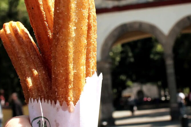 Frida Kahlo VIP [Museum Tickets Included] Walk, Markets & Churros - Jardín Centenario plus San Juan Bautista Church: the park, the coyote sculpture, and the contrast